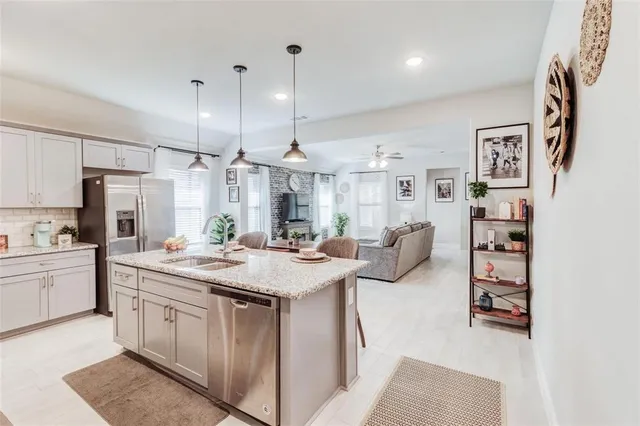 a kitchen with stainless steel appliances granite countertop a sink and cabinets