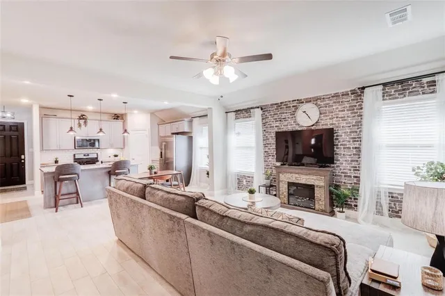 a living room with furniture a fireplace and a flat screen tv