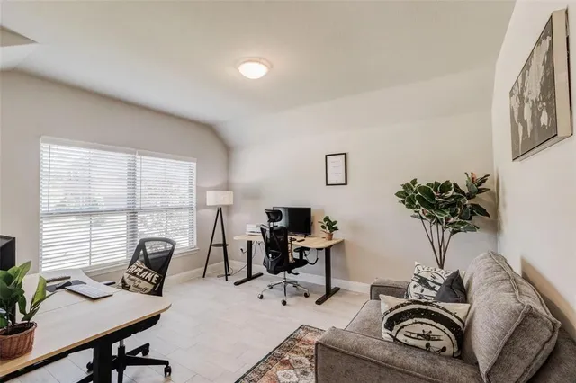 a work room with furniture and a potted plant