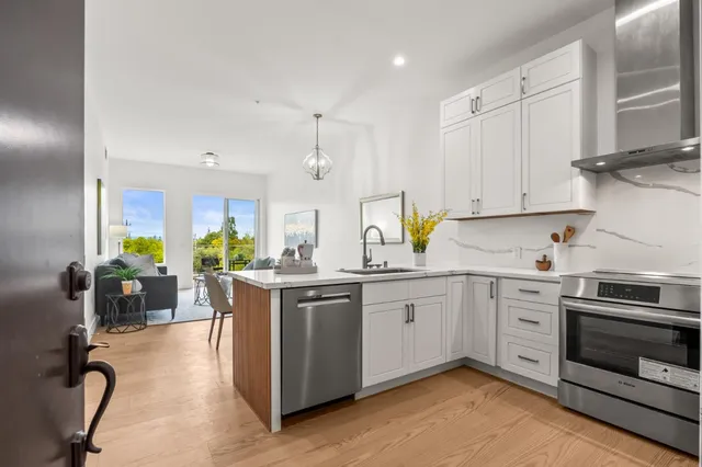 a kitchen with a sink appliances and cabinets