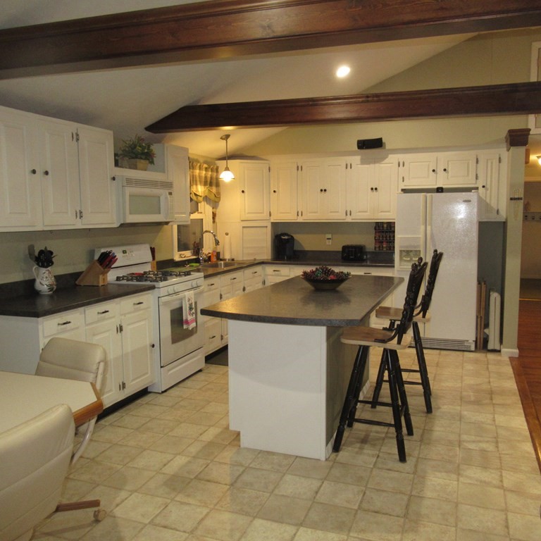 19 Haskell Road Pepperell, MA 01463 - Photo 11 of 40 a kitchen with stainless steel appliances a stove a sink cabinets and a refrigerator