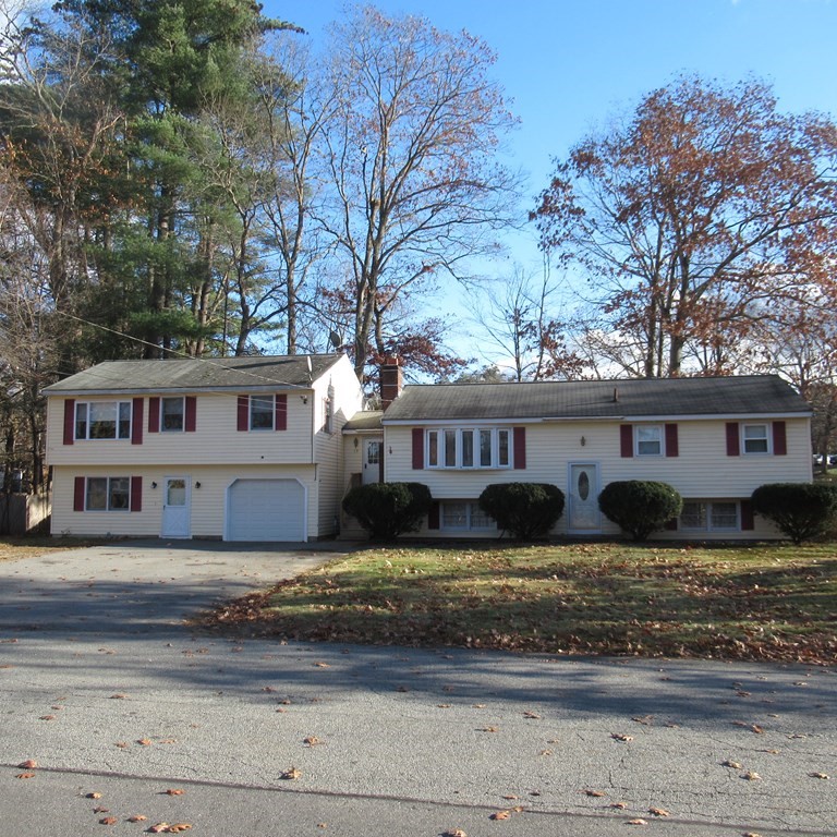 19 Haskell Road Pepperell, MA 01463 - Photo 2 of 40 a view of a big house with large windows and a large tree