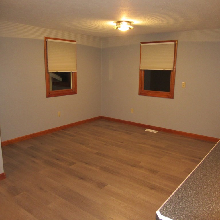 19 Haskell Road Pepperell, MA 01463 - Photo 33 of 40 an empty room with wooden floor and windows