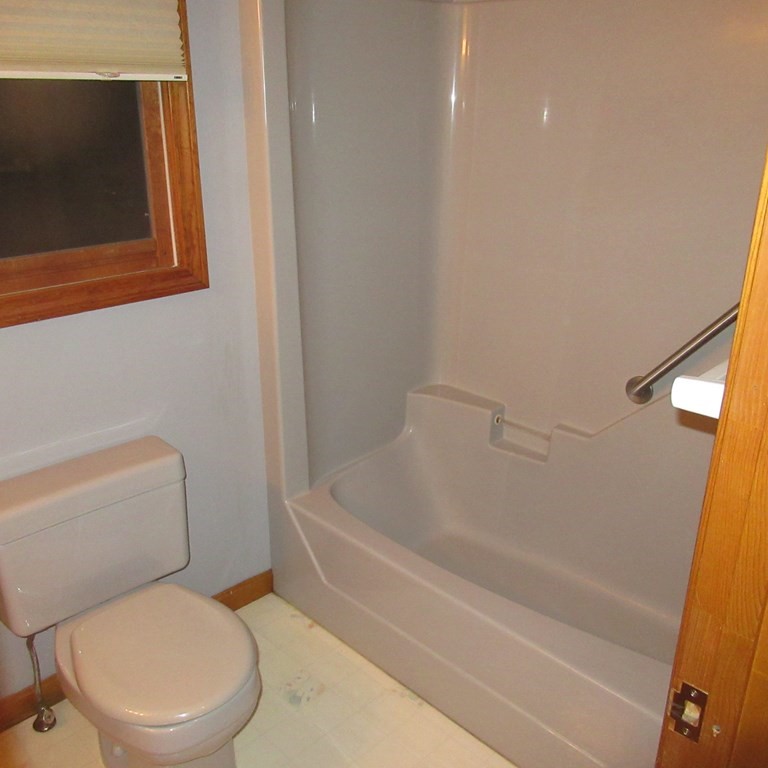 19 Haskell Road Pepperell, MA 01463 - Photo 37 of 40 a white toilet sitting next to a bath tub