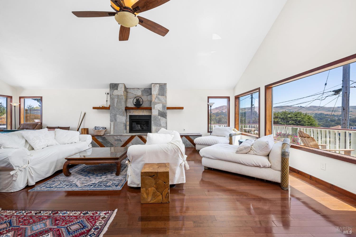 1846 Whaleship Road Bodega Bay, CA 94923 - Photo 20 of 69 a living room with furniture large window and a fireplace