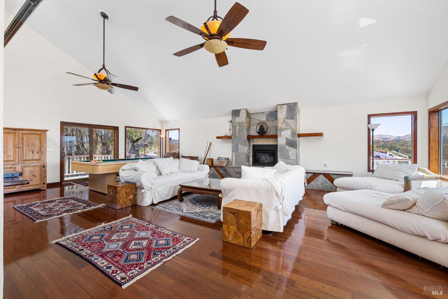 1846 Whaleship Road Bodega Bay, CA 94923 - Photo 21 of 69 a living room with furniture a rug and a chandelier