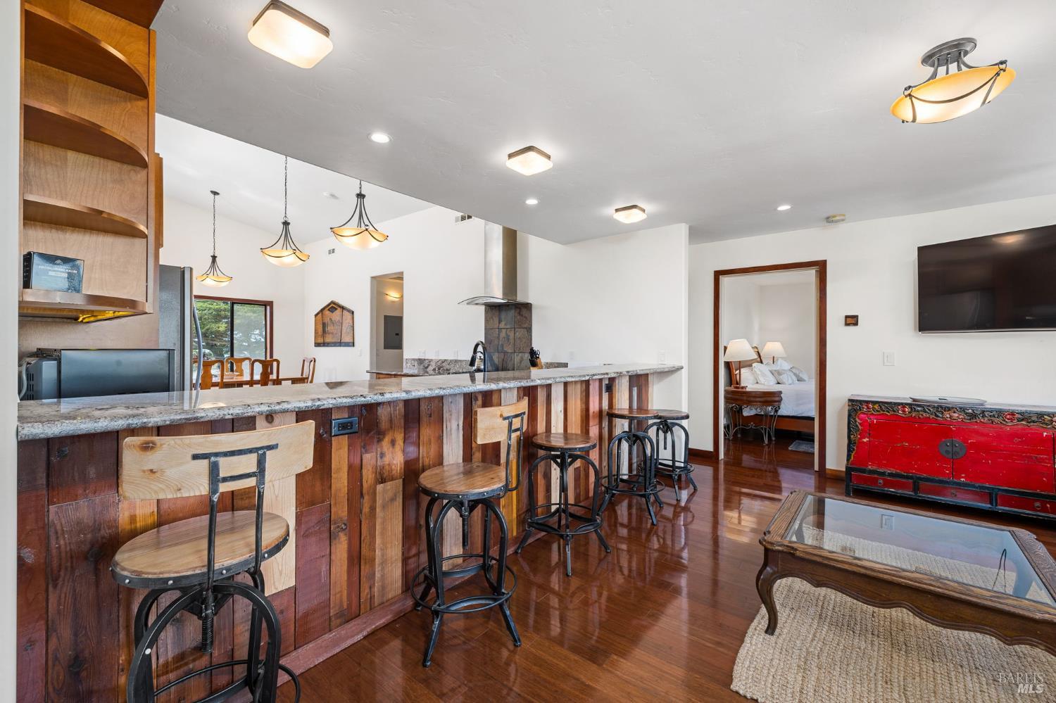 1846 Whaleship Road Bodega Bay, CA 94923 - Photo 25 of 69 a very nice looking kitchen with granite countertop a table chairs stove a sink and dishwasher