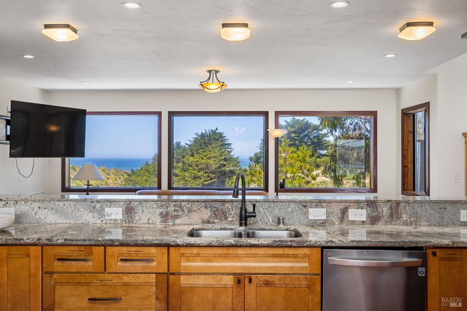 1846 Whaleship Road Bodega Bay, CA 94923 - Photo 33 of 69 a kitchen with granite countertop a sink and a window
