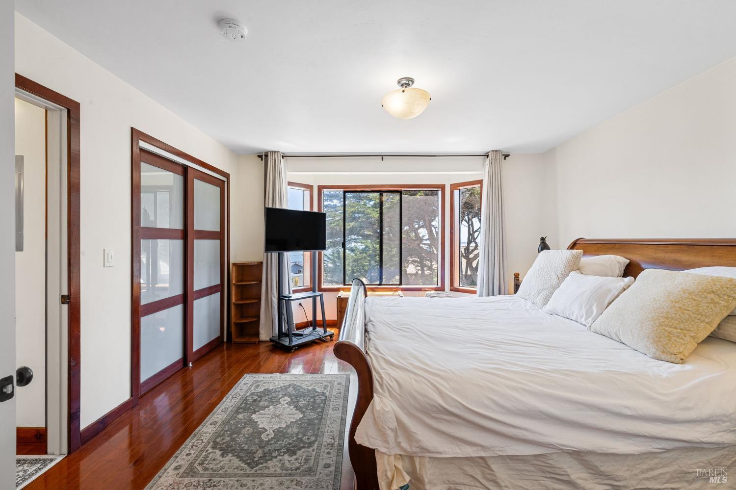 1846 Whaleship Road Bodega Bay, CA 94923 - Photo 36 of 69 a bedroom with a large bed and a large window