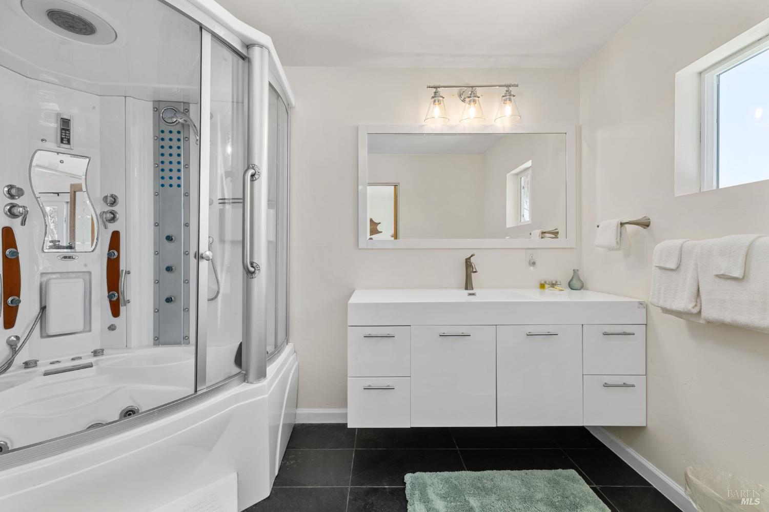 1846 Whaleship Road Bodega Bay, CA 94923 - Photo 50 of 69 a spacious bathroom with a double vanity sink a mirror and a bathtub