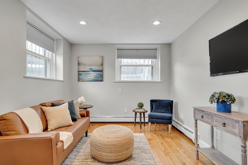 60 Charlesgate West, Unit BA Boston, MA 02215 - Photo 18 of 37 a living room with furniture and a flat screen tv