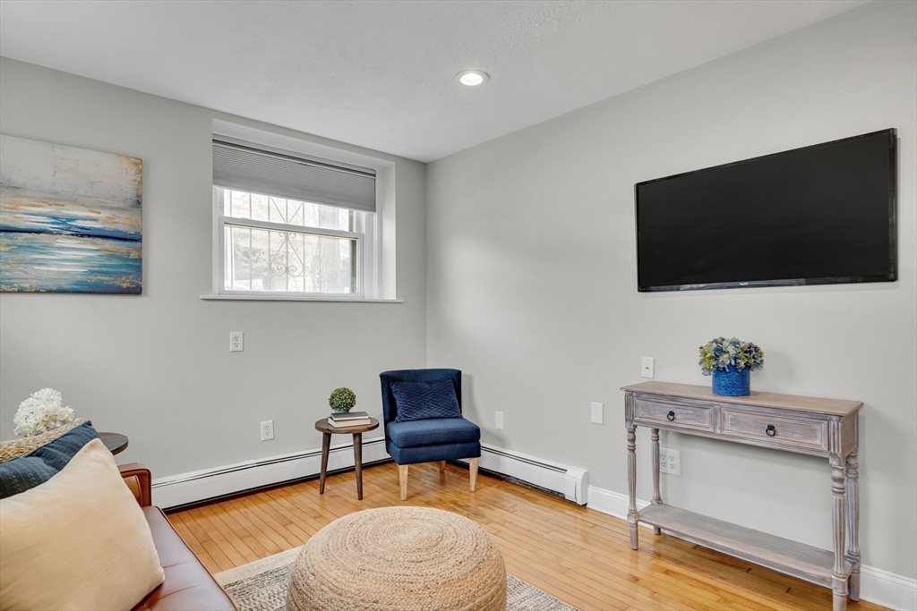 60 Charlesgate West, Unit BA Boston, MA 02215 - Photo 22 of 37 a living room with furniture and a flat screen tv