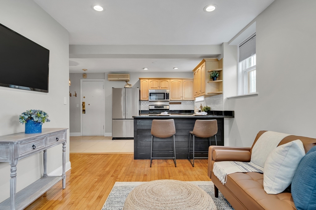 60 Charlesgate West, Unit BA Boston, MA 02215 - Photo 24 of 37 a living room with furniture and a flat screen tv