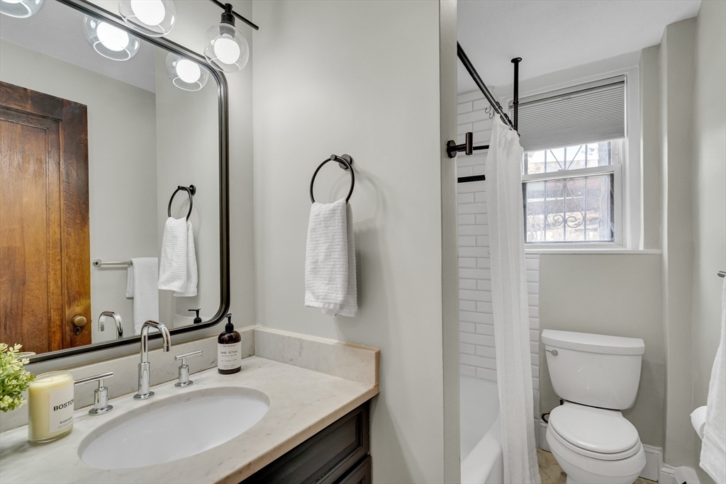 60 Charlesgate West, Unit BA Boston, MA 02215 - Photo 28 of 37 a bathroom with a sink a toilet and shower