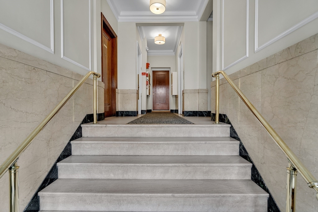 60 Charlesgate West, Unit BA Boston, MA 02215 - Photo 32 of 37 a view of staircase with white walls and a window