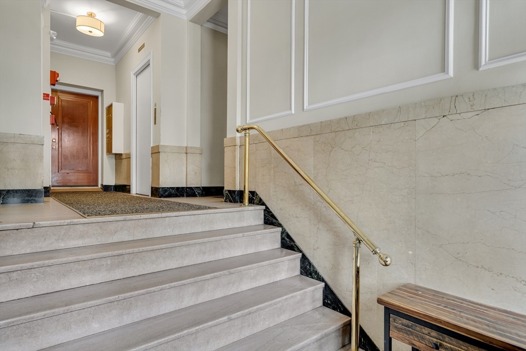 60 Charlesgate West, Unit BA Boston, MA 02215 - Photo 33 of 37 a view of staircase with white walls and railing