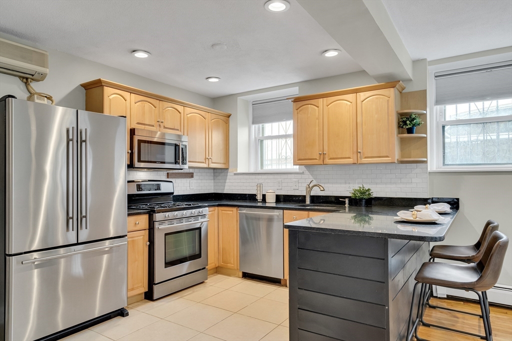 60 Charlesgate West, Unit BA Boston, MA 02215 - Photo 10 of 37 a kitchen with a refrigerator and a stove top oven