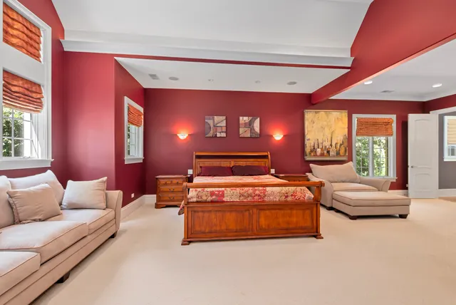 a spacious bedroom with a bed and a large window