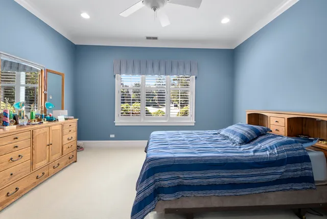 a bedroom with a bed and window