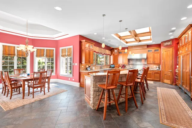 a dining area with furniture and a large window