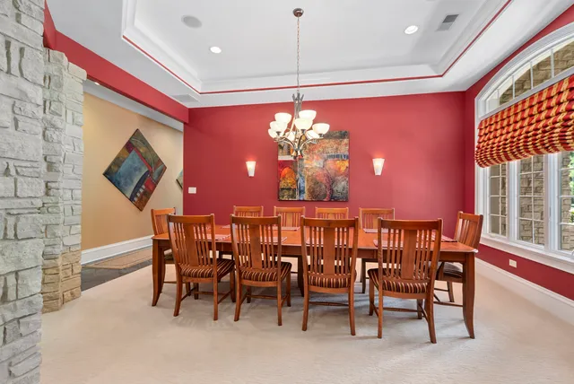 a view of a dining room with furniture and chandelier
