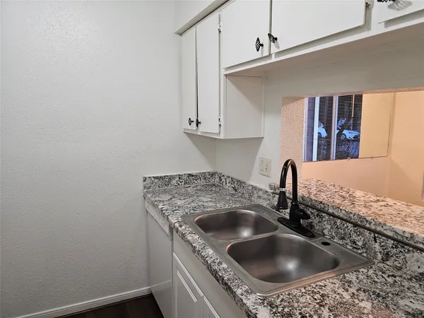 a kitchen with a sink and cabinets