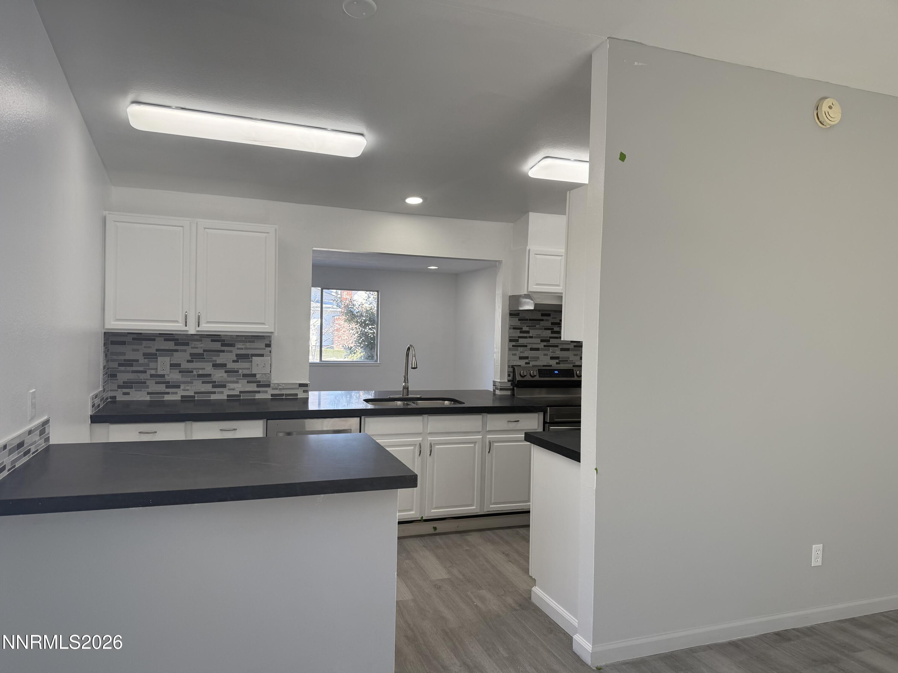 995 Sage View Drive Sparks, NV 89434 - Photo 2 of 13 a kitchen with stainless steel appliances granite countertop a sink and cabinets