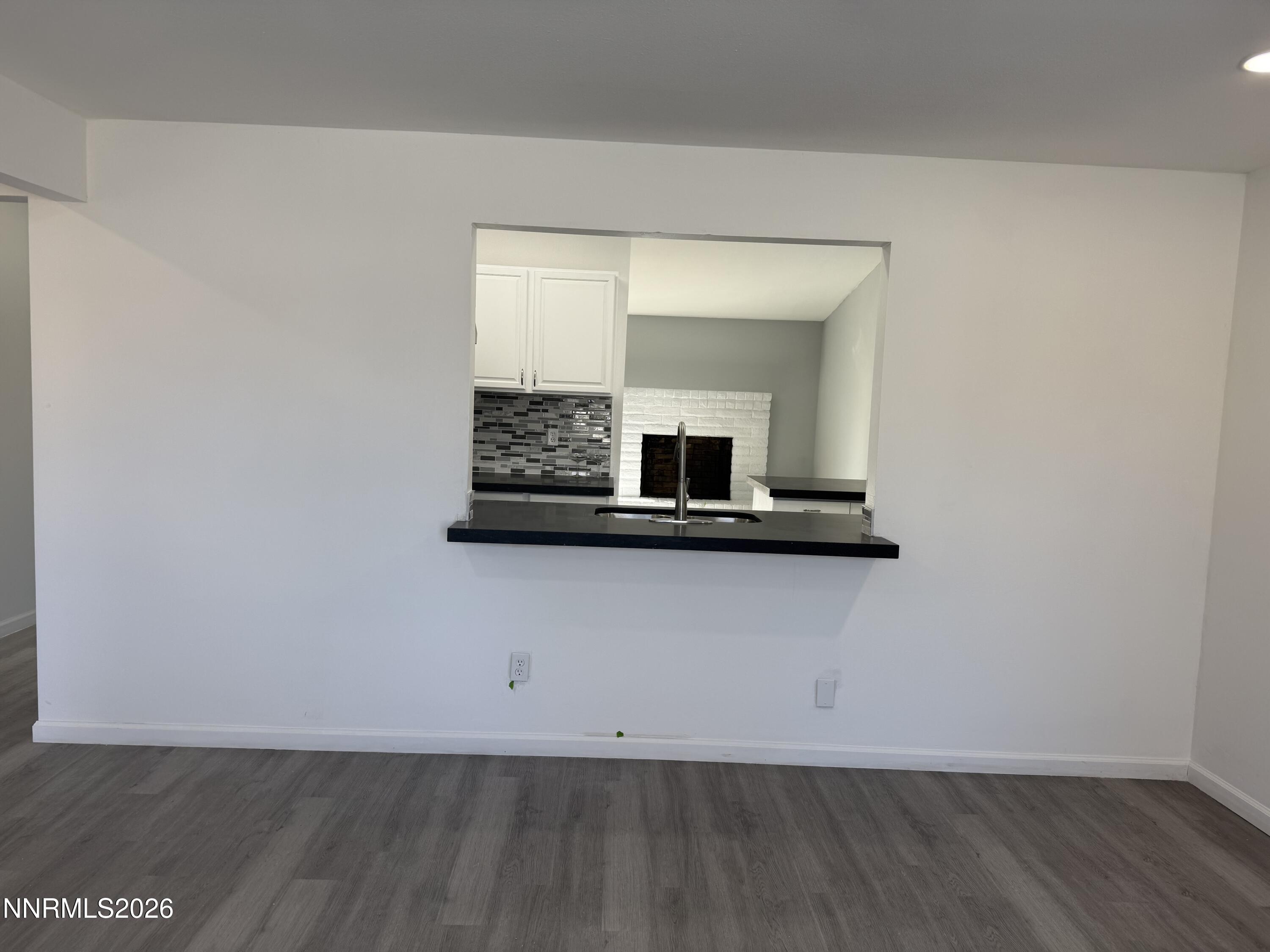 995 Sage View Drive Sparks, NV 89434 - Photo 3 of 13 a view of an empty room with wooden floor and a window