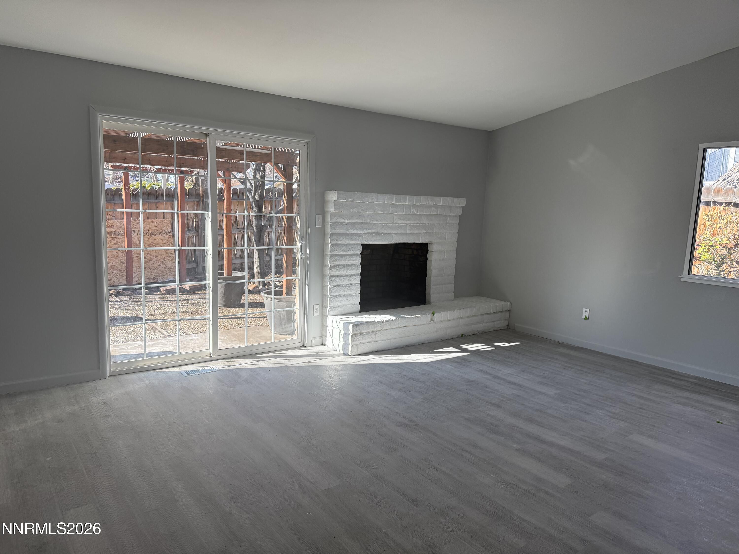 995 Sage View Drive Sparks, NV 89434 - Photo 5 of 13 a view of empty room with wooden floor and fireplace