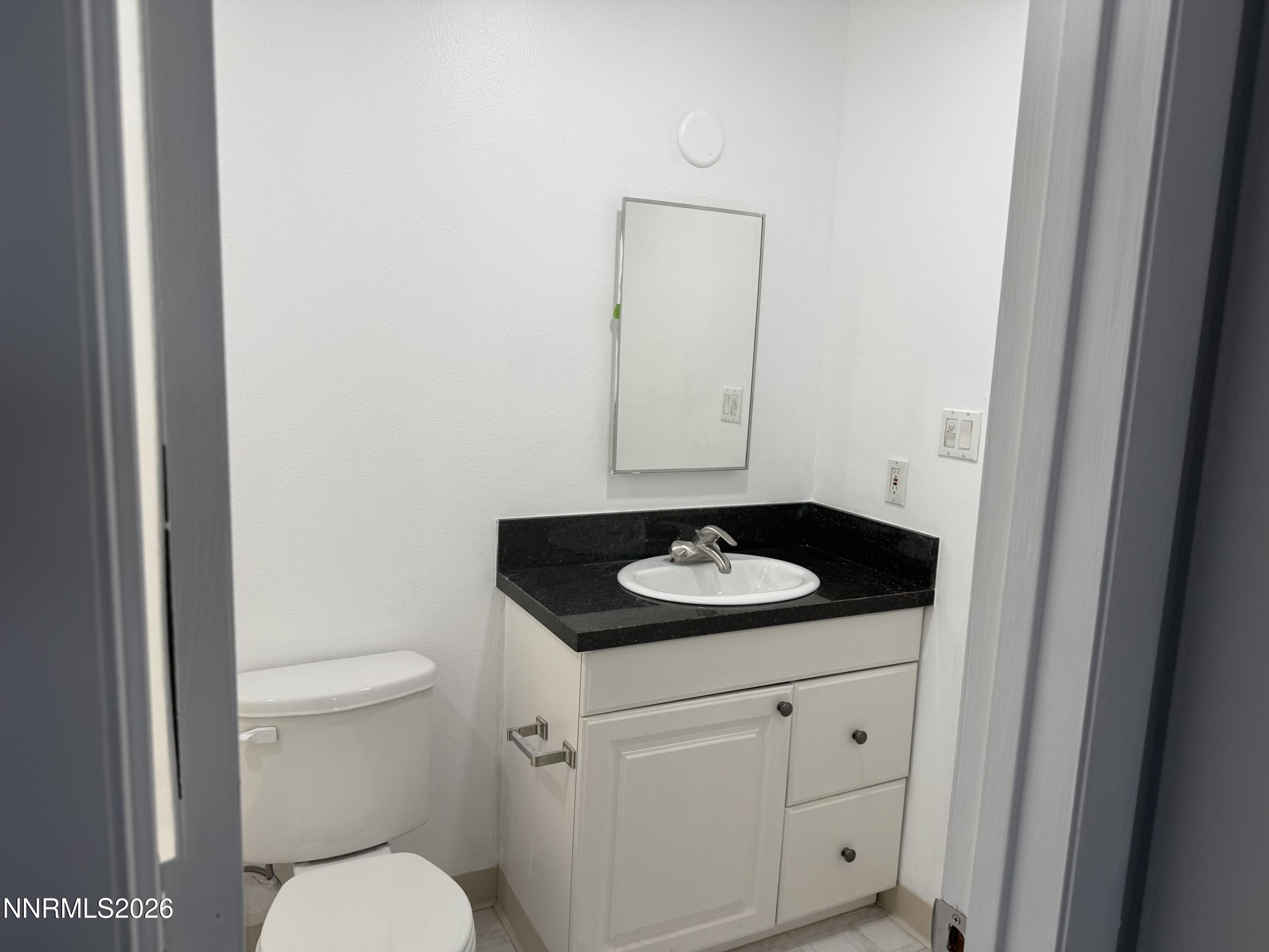995 Sage View Drive Sparks, NV 89434 - Photo 9 of 13 a bathroom with a granite countertop sink and a toilet