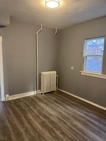 a view of a room with wooden floor and small space