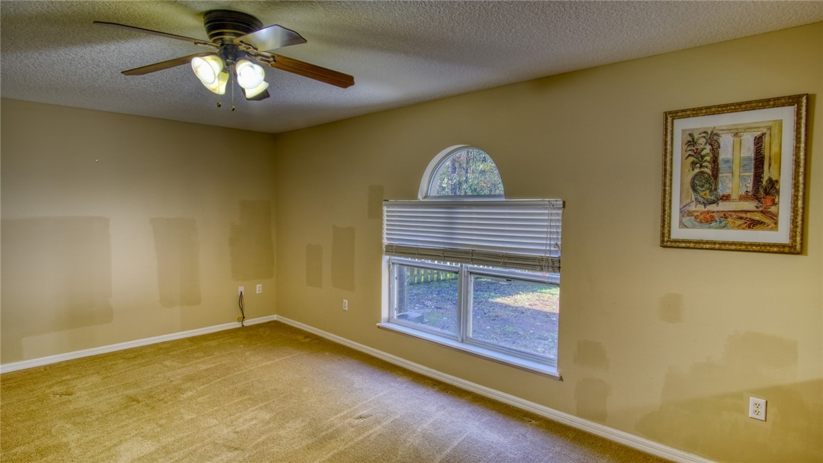76367 Longleaf Loop Yulee, FL 32097 - Photo 7 of 15 a view of room with painting and a ceiling fan