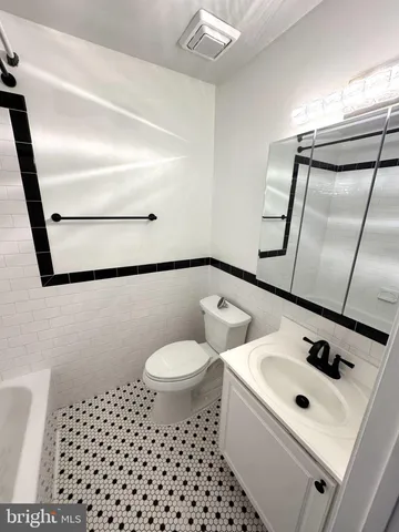 a white toilet sitting next to a bathroom sink