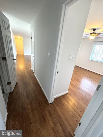 a view of hallway with wooden floor