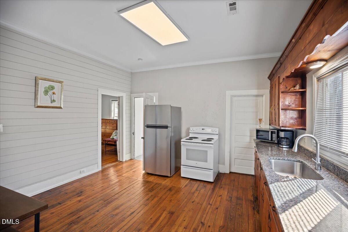 123 Kerr Drive Roxboro, NC 27573 - Photo 12 of 33 a room with wooden floors and white walls