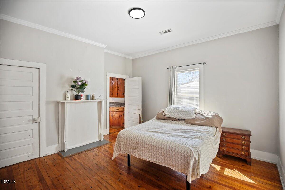 123 Kerr Drive Roxboro, NC 27573 - Photo 14 of 33 a bedroom with a bed and wooden floor