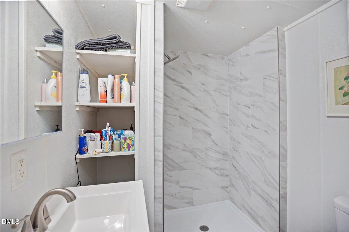 123 Kerr Drive Roxboro, NC 27573 - Photo 17 of 33 a bathroom with a bathtub and sink