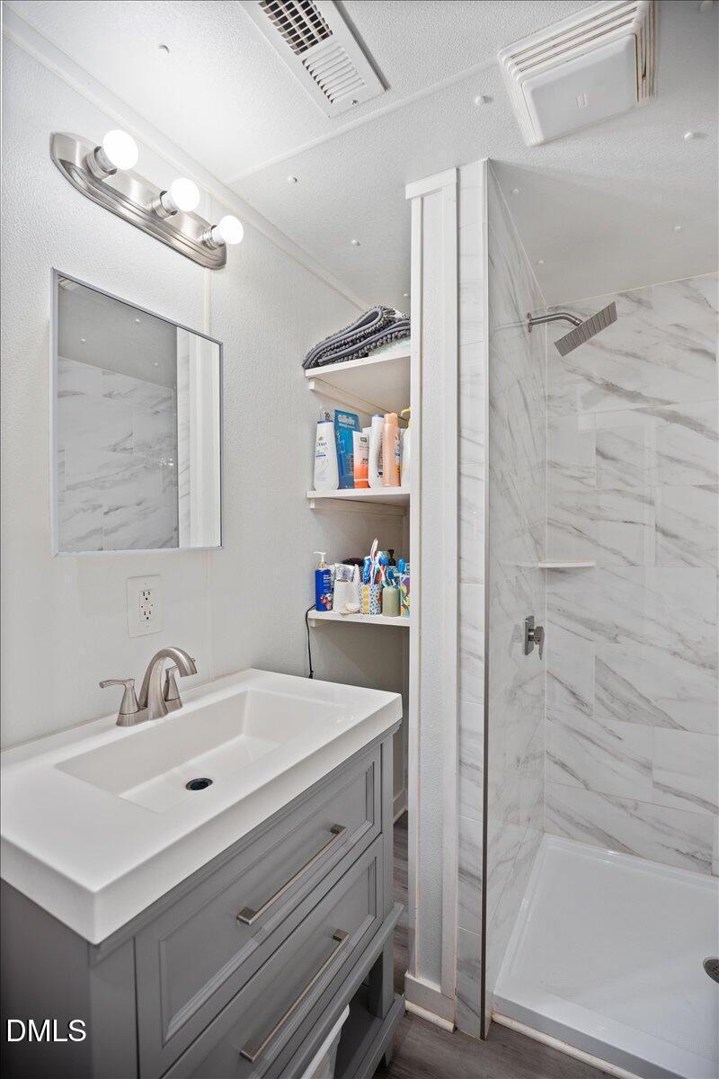 123 Kerr Drive Roxboro, NC 27573 - Photo 18 of 33 a bathroom with a sink and a mirror