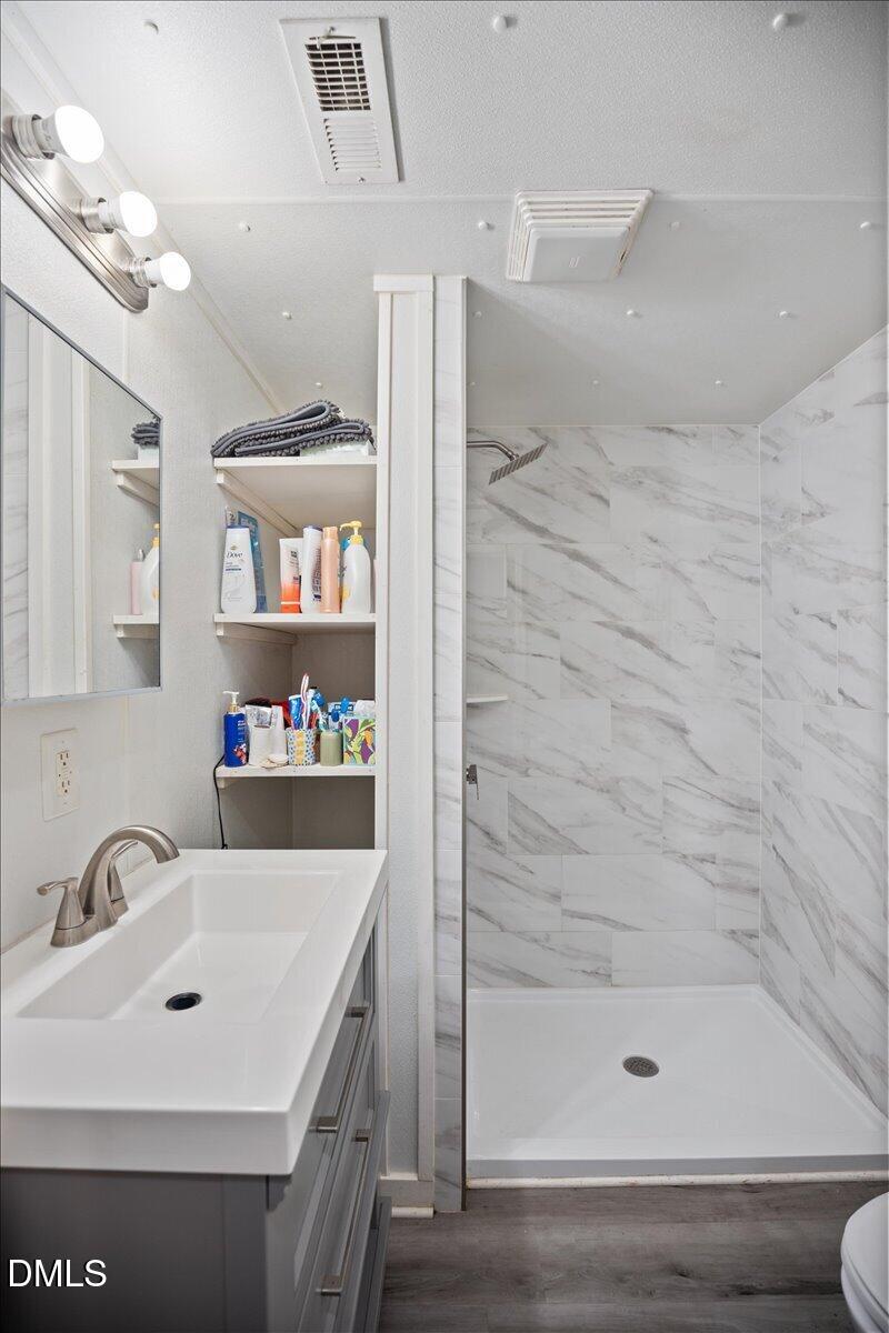 123 Kerr Drive Roxboro, NC 27573 - Photo 19 of 33 a bathroom with a sink a toilet and shower