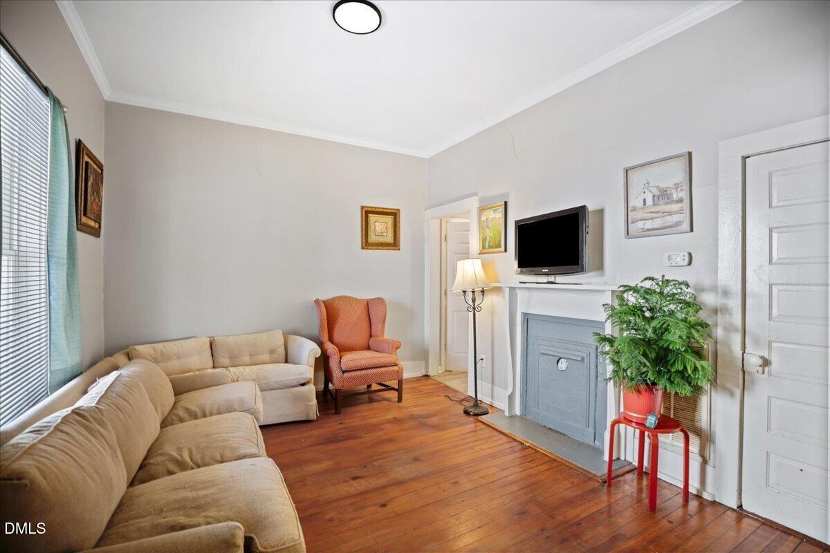 123 Kerr Drive Roxboro, NC 27573 - Photo 7 of 33 a living room with furniture a flat screen tv and a potted plant