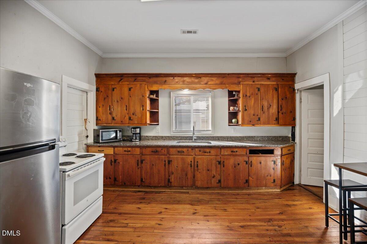 123 Kerr Drive Roxboro, NC 27573 - Photo 9 of 33 a kitchen with stainless steel appliances granite countertop a stove a sink and a refrigerator