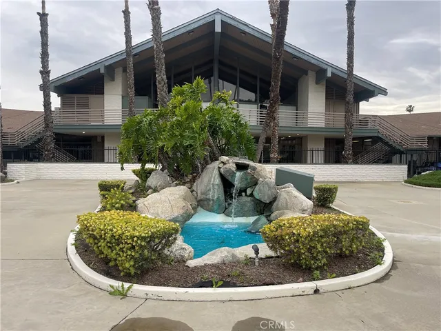 a view of a house with backyard and sitting area
