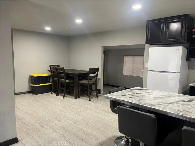 a kitchen with kitchen island a sink stainless steel appliances and dining table