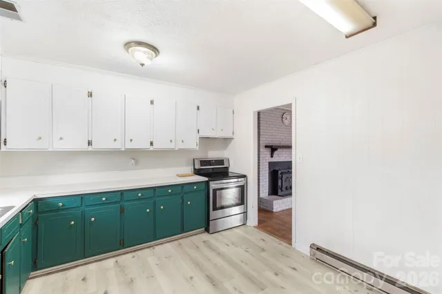 a kitchen with stainless steel appliances granite countertop a refrigerator and a stove