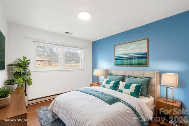 a bedroom with a bed and a potted plant