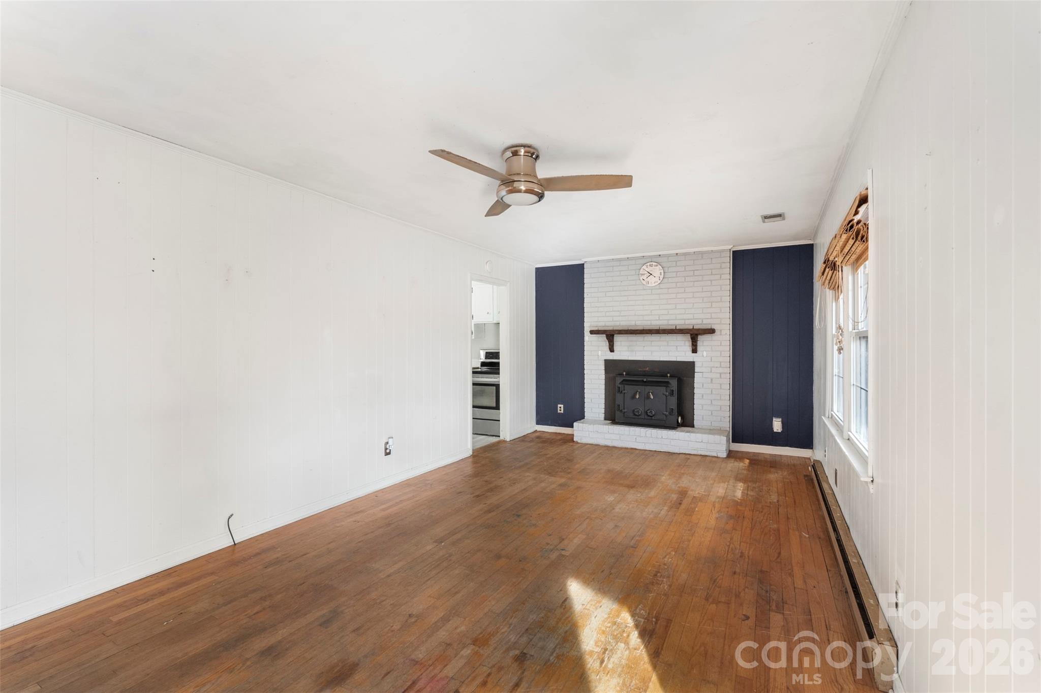 1152 Faulkner Road Clover, SC 29710 - Photo 6 of 39 a view of a livingroom with a fireplace and a ceiling fan