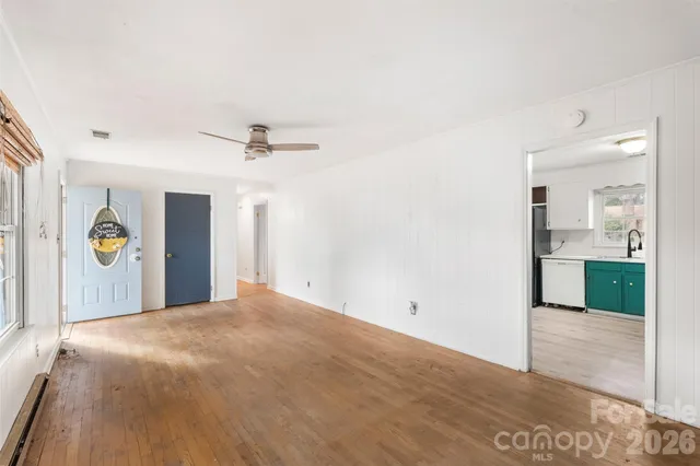 a view of a big room with windows and cabinet
