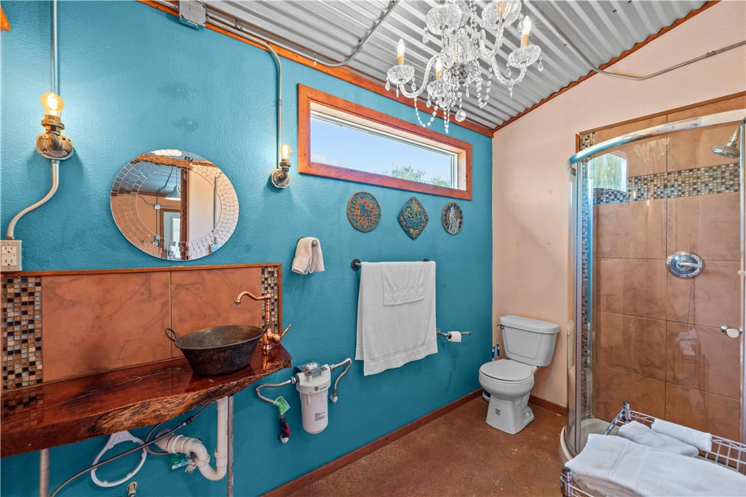 718 County Road 2340 East Riviera, TX 78379 - Photo 18 of 25 a bathroom with a toilet a sink and shower curtain