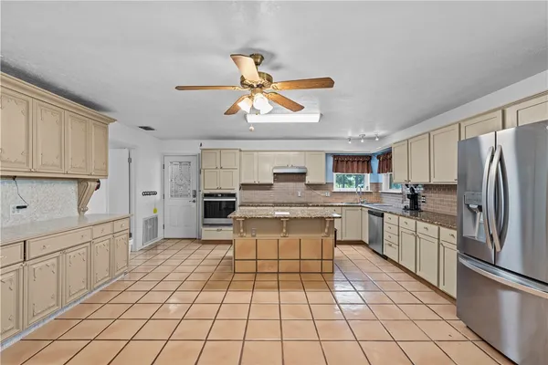 a kitchen with a sink cabinets and appliances