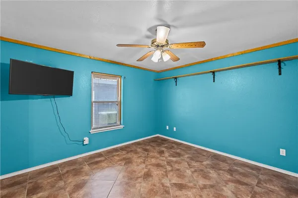 a view of a room with a fan and a window